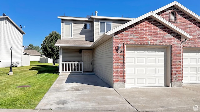 652 W 800 N Unit 112, Clinton, UT 84015 - view of front of property featuring brick siding, a front yard, concrete driveway, and a garage