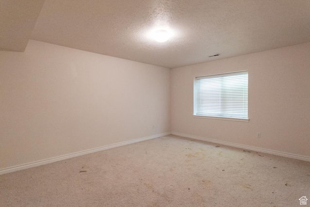 274 E Park Knoll Cir, Sandy, UT 84070 - empty room featuring a textured ceiling, light colored carpet, and baseboards