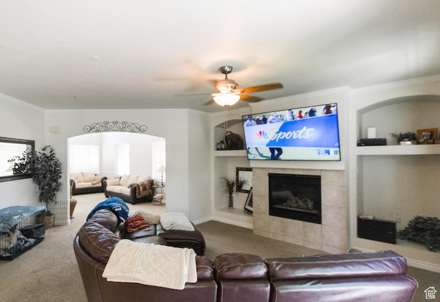 274 E Park Knoll Cir, Sandy, UT 84070 - living area with carpet flooring, crown molding, a tiled fireplace, built in features, and ceiling fan