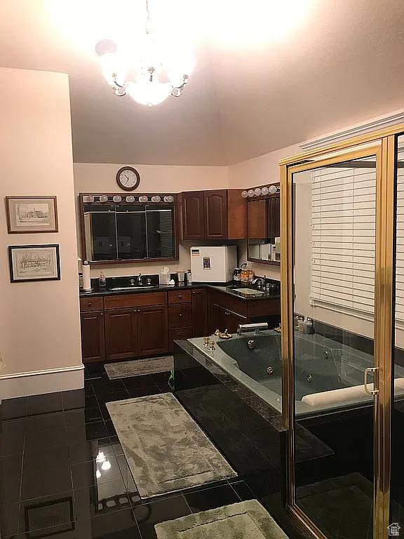 4093 Imperial Way, Provo, UT 84604 - kitchen featuring dark countertops, a chandelier, dark tile patterned flooring, a sink, and dark brown cabinets