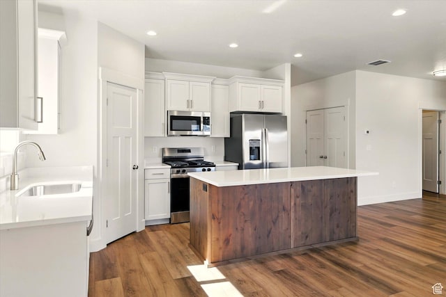 222 W 825 S, Willard, UT 84340 - kitchen featuring stainless steel appliances, a sink, dark wood-style flooring, white cabinets, and recessed lighting