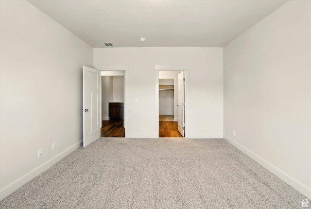 222 W 825 S, Willard, UT 84340 - unfurnished bedroom with carpet flooring, a walk in closet, baseboards, and a closet