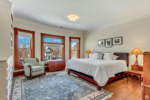 15 S 1200 E, Salt Lake City, UT 84102 - bedroom with multiple windows, wood finished floors, and crown molding