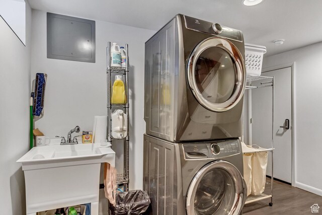 15 S 1200 E, Salt Lake City, UT 84102 - laundry room featuring stacked washer and clothes dryer and wood finished floors