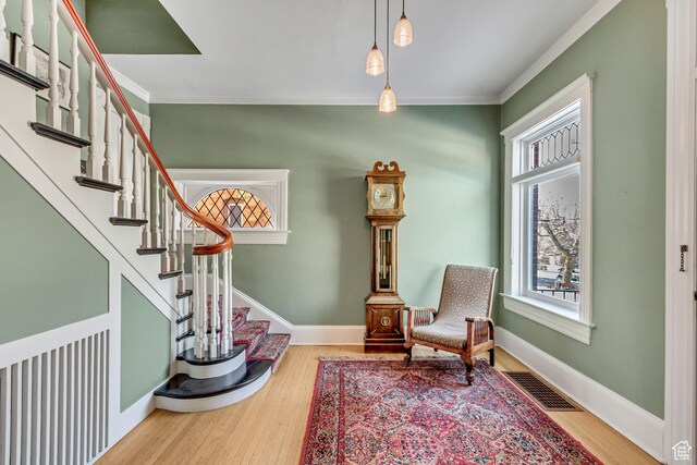 15 S 1200 E, Salt Lake City, UT 84102 - sitting room featuring plenty of natural light, crown molding, wood finished floors, stairs, and baseboards