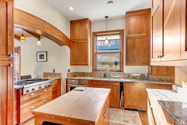 15 S 1200 E, Salt Lake City, UT 84102 - kitchen with wooden counters, stainless steel appliances, a sink, decorative light fixtures, and light wood-type flooring
