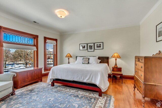 15 S 1200 E, Salt Lake City, UT 84102 - bedroom with light wood finished floors, crown molding, and baseboards