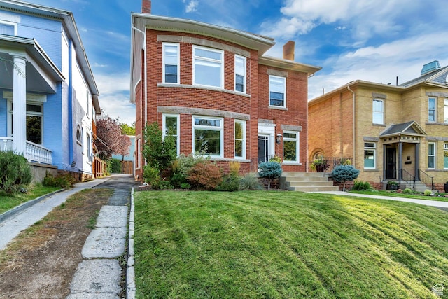 15 S 1200 E, Salt Lake City, UT 84102 - townhome / multi-family property with a chimney, brick siding, and a front yard