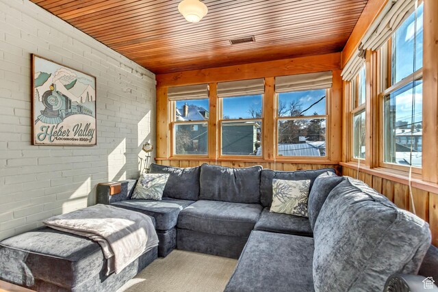 15 S 1200 E, Salt Lake City, UT 84102 - living area with wooden ceiling, brick wall, and wooden walls