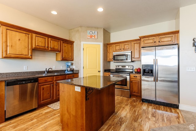 691 N 240 E Unit 39, Smithfield, UT 84335 - kitchen with appliances with stainless steel finishes, a sink, a kitchen island, light wood-style floors, and recessed lighting