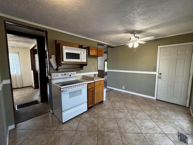 635 N Chimesview Cir E, Tooele, UT 84074 - kitchen featuring white appliances, a ceiling fan, a textured ceiling, brown cabinets, and light tile patterned floors