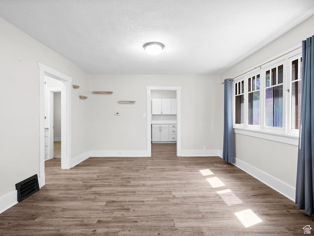 719 E 22nd St, Ogden, UT 84401 - spare room with baseboards, wood finished floors, and a textured ceiling