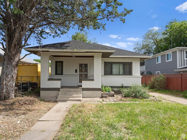 719 E 22nd St, Ogden, UT 84401 - bungalow-style home featuring brick siding, covered porch, roof with shingles, and board and batten siding