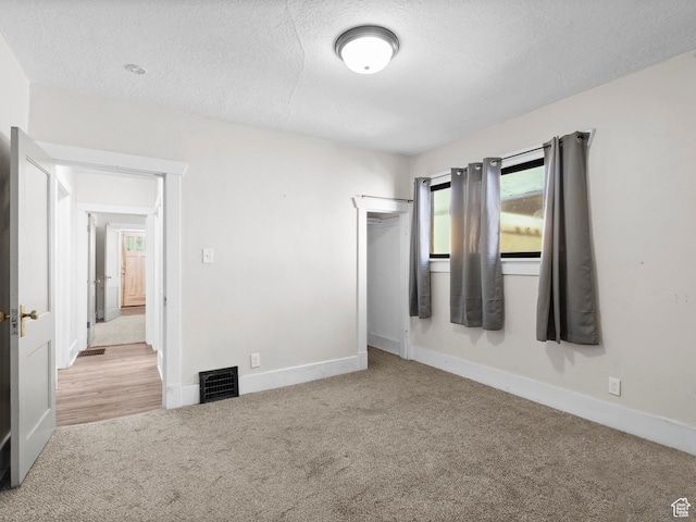 719 E 22nd St, Ogden, UT 84401 - unfurnished bedroom with carpet floors, a textured ceiling, a closet, and baseboards