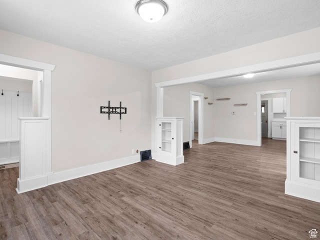 719 E 22nd St, Ogden, UT 84401 - unfurnished living room featuring wood finished floors and baseboards