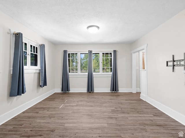 719 E 22nd St, Ogden, UT 84401 - unfurnished room featuring a textured ceiling, wood finished floors, and baseboards