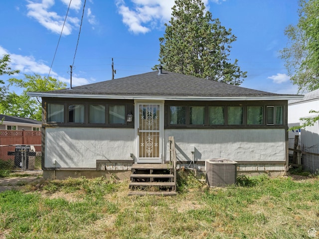 719 E 22nd St, Ogden, UT 84401 - back of property featuring central AC, roof with shingles, stucco siding, and entry steps