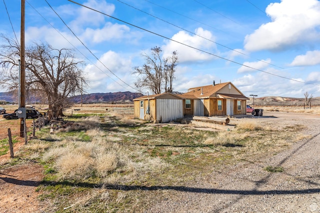 1725 N State St, Sigurd, UT 84657 - back of house featuring a mountain view and a storage shed