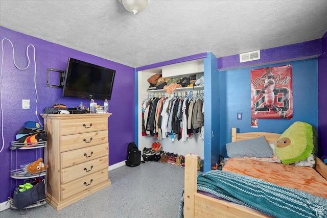 2137 W 6200 S, Salt Lake City, UT 84129 - bedroom with baseboards, a closet, speckled floor, and a textured ceiling