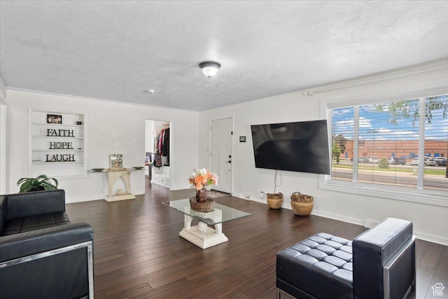 2137 W 6200 S, Salt Lake City, UT 84129 - living room featuring a textured ceiling, built in features, baseboards, and wood finished floors