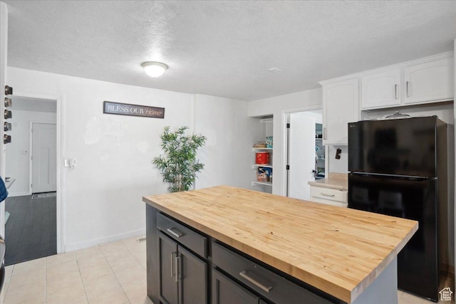 2137 W 6200 S, Salt Lake City, UT 84129 - kitchen with freestanding refrigerator, butcher block countertops, white cabinetry, a textured ceiling, and a kitchen island