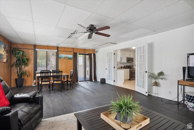 2137 W 6200 S, Salt Lake City, UT 84129 - living room featuring french doors, wood finished floors, ceiling fan, wood walls, and a drop ceiling