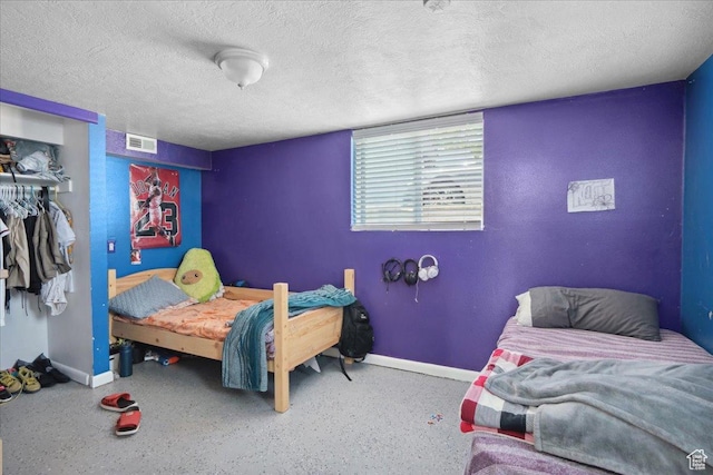 2137 W 6200 S, Salt Lake City, UT 84129 - bedroom with baseboards, a closet, and a textured ceiling