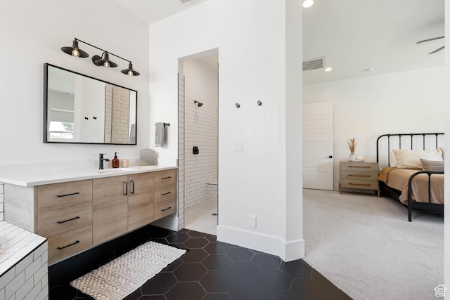 3322 S 2240 E, St George, UT 84790 - ensuite bathroom featuring vanity, a tile shower, tile patterned floors, baseboards, and recessed lighting
