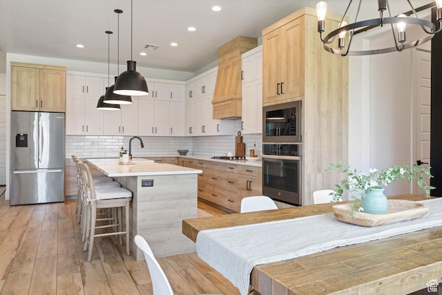3322 S 2240 E, St George, UT 84790 - kitchen featuring stainless steel appliances, a chandelier, recessed lighting, light countertops, and an island with sink