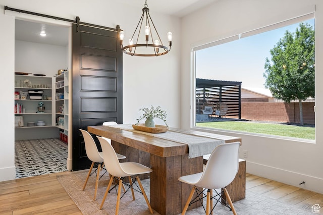 3322 S 2240 E, St George, UT 84790 - dining room featuring a barn door, wood finished floors, plenty of natural light, and a chandelier