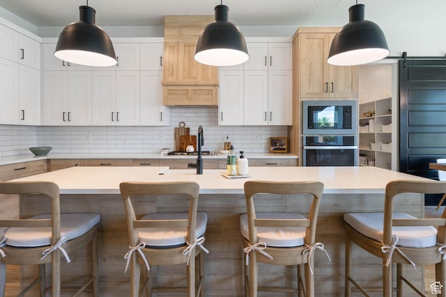 3322 S 2240 E, St George, UT 84790 - kitchen with stainless steel appliances, backsplash, light countertops, an island with sink, and a kitchen bar