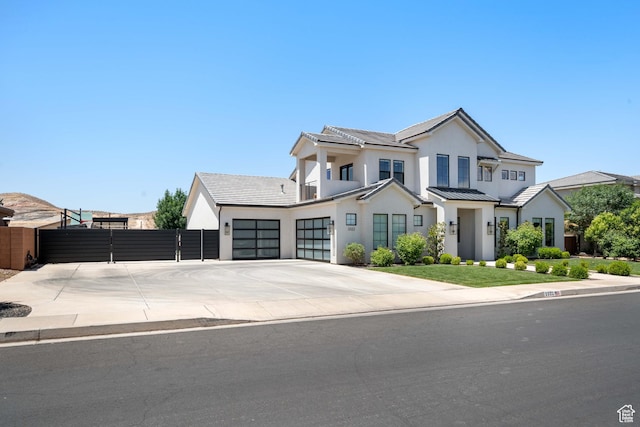 3322 S 2240 E, St George, UT 84790 - view of front of house with a garage, concrete driveway, a standing seam roof, stucco siding, and a gate