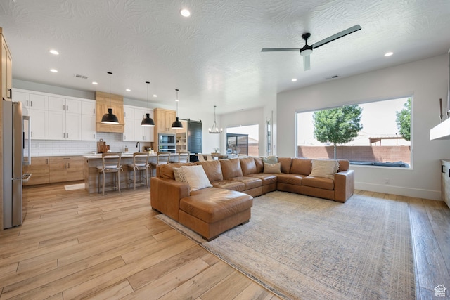 3322 S 2240 E, St George, UT 84790 - living room with light wood-style floors, recessed lighting, ceiling fan, and baseboards
