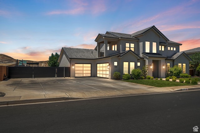 3322 S 2240 E, St George, UT 84790 - view of front of home with driveway, a gate, an attached garage, stucco siding, and a standing seam roof