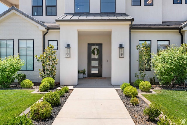 3322 S 2240 E, St George, UT 84790 - doorway to property featuring a standing seam roof, stucco siding, and a lawn