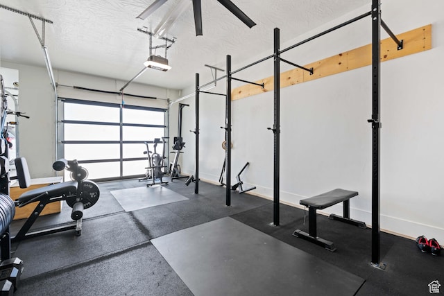 3322 S 2240 E, St George, UT 84790 - exercise room featuring a garage, a textured ceiling, and baseboards