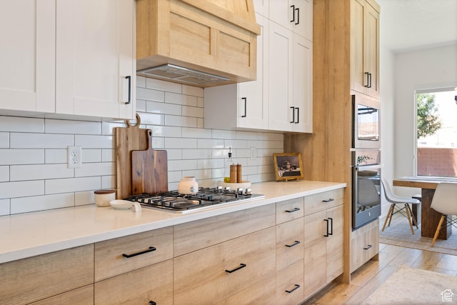 3322 S 2240 E, St George, UT 84790 - kitchen featuring custom range hood, light wood-style flooring, tasteful backsplash, light countertops, and light brown cabinets