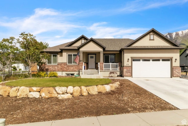 276 N Elk Ridge Dr, Elk Ridge, UT 84651 - craftsman-style home featuring brick siding, stucco siding, a front lawn, a garage, and concrete driveway