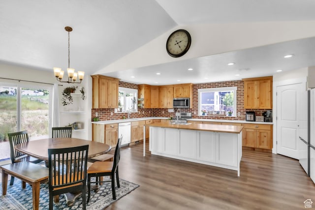 276 N Elk Ridge Dr, Elk Ridge, UT 84651 - kitchen with stainless steel microwave, dishwashing machine, vaulted ceiling, light countertops, and decorative backsplash