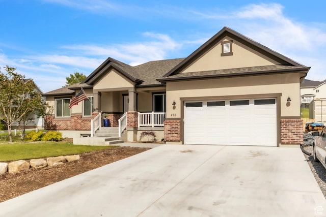 276 N Elk Ridge Dr, Elk Ridge, UT 84651 - view of front of home with brick siding, stucco siding, an attached garage, covered porch, and concrete driveway
