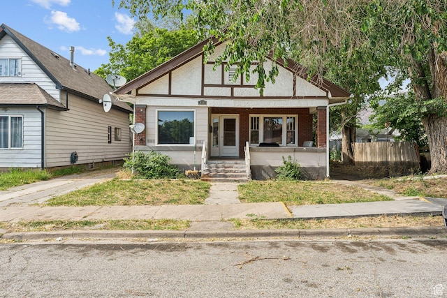 968 E Capitol St S, Ogden, UT 84401 - tudor-style house with a porch and brick siding