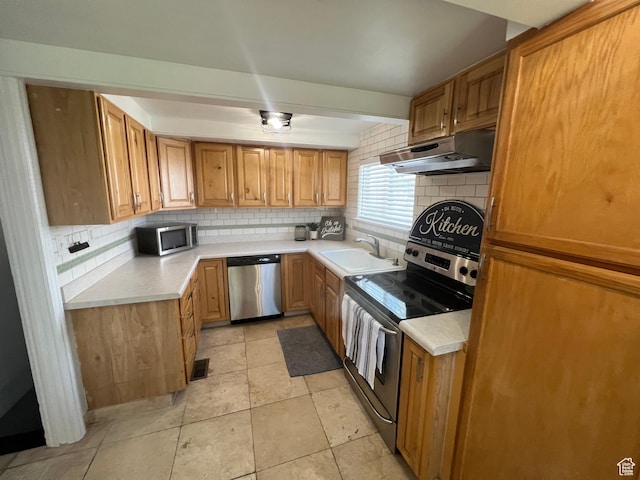 2717 S Orchard Dr, Bountiful, UT 84010 - kitchen featuring stainless steel appliances, under cabinet range hood, tasteful backsplash, and light countertops