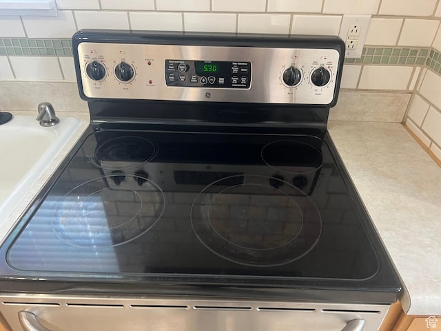 2717 S Orchard Dr, Bountiful, UT 84010 - kitchen view of stainless steel electric stove and decorative backsplash