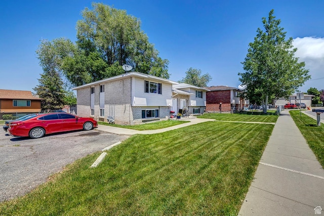 174 W Foxbridge Dr S, Midvale, UT 84047 - view of front of property featuring brick siding and a front yard