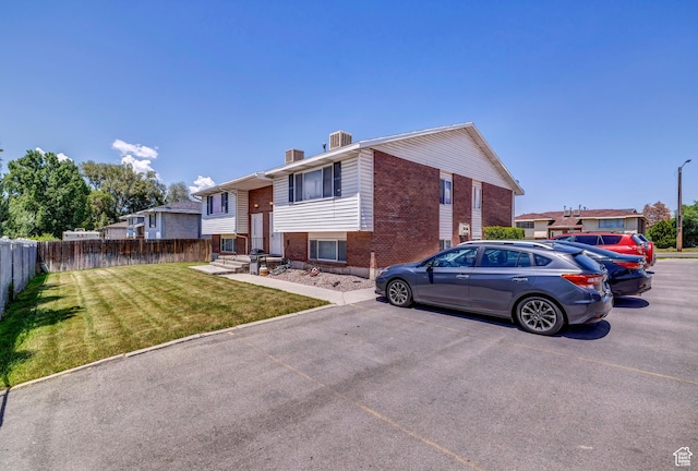 195 W 8480 S, Midvale, UT 84047 - split foyer home featuring brick siding, uncovered parking, and a chimney