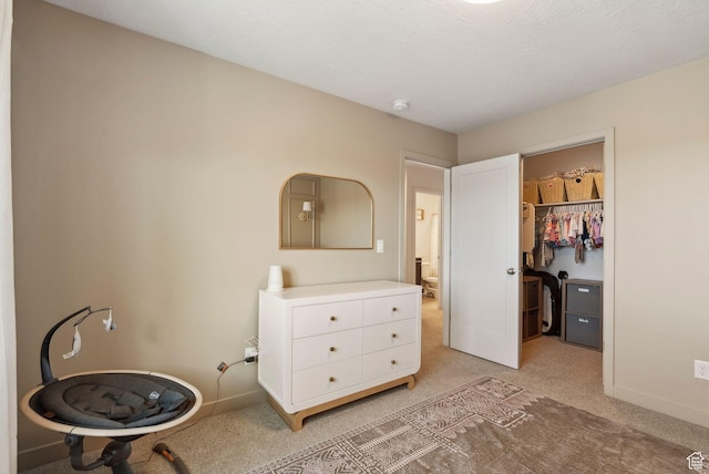 1006 W Firelock Way S, Bluffdale, UT 84065 - bedroom featuring light carpet, a walk in closet, baseboards, and a closet