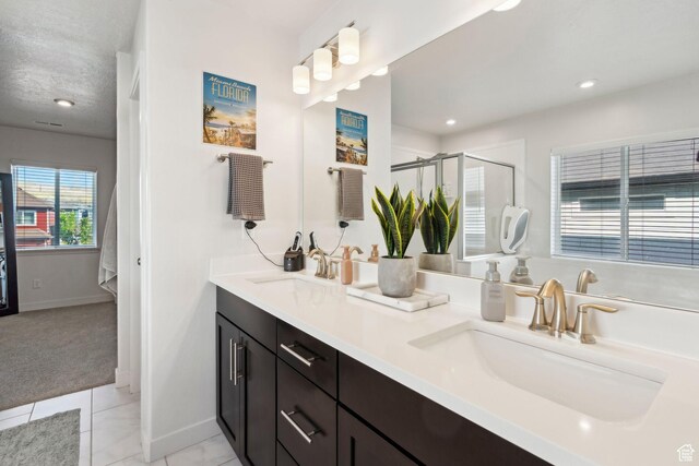 1006 W Firelock Way S, Bluffdale, UT 84065 - bathroom with double vanity, a stall shower, tile patterned flooring, baseboards, and recessed lighting