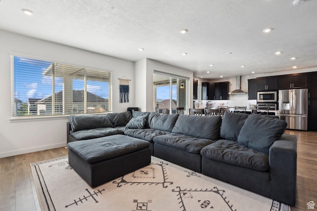 1006 W Firelock Way S, Bluffdale, UT 84065 - living area with baseboards, plenty of natural light, recessed lighting, a textured ceiling, and wood finished floors