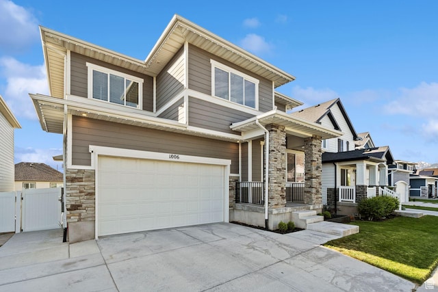 1006 W Firelock Way S, Bluffdale, UT 84065 - view of front of home featuring stone siding, a porch, an attached garage, driveway, and a gate