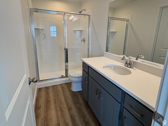 6901 W S Jordan Pkwy, South Jordan, UT 84009 - bathroom featuring toilet, a stall shower, vanity, and wood finished floors